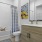a bathroom with a mirror tub toilet and sink
