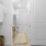 a rcloset with white doors and a basket on the floor